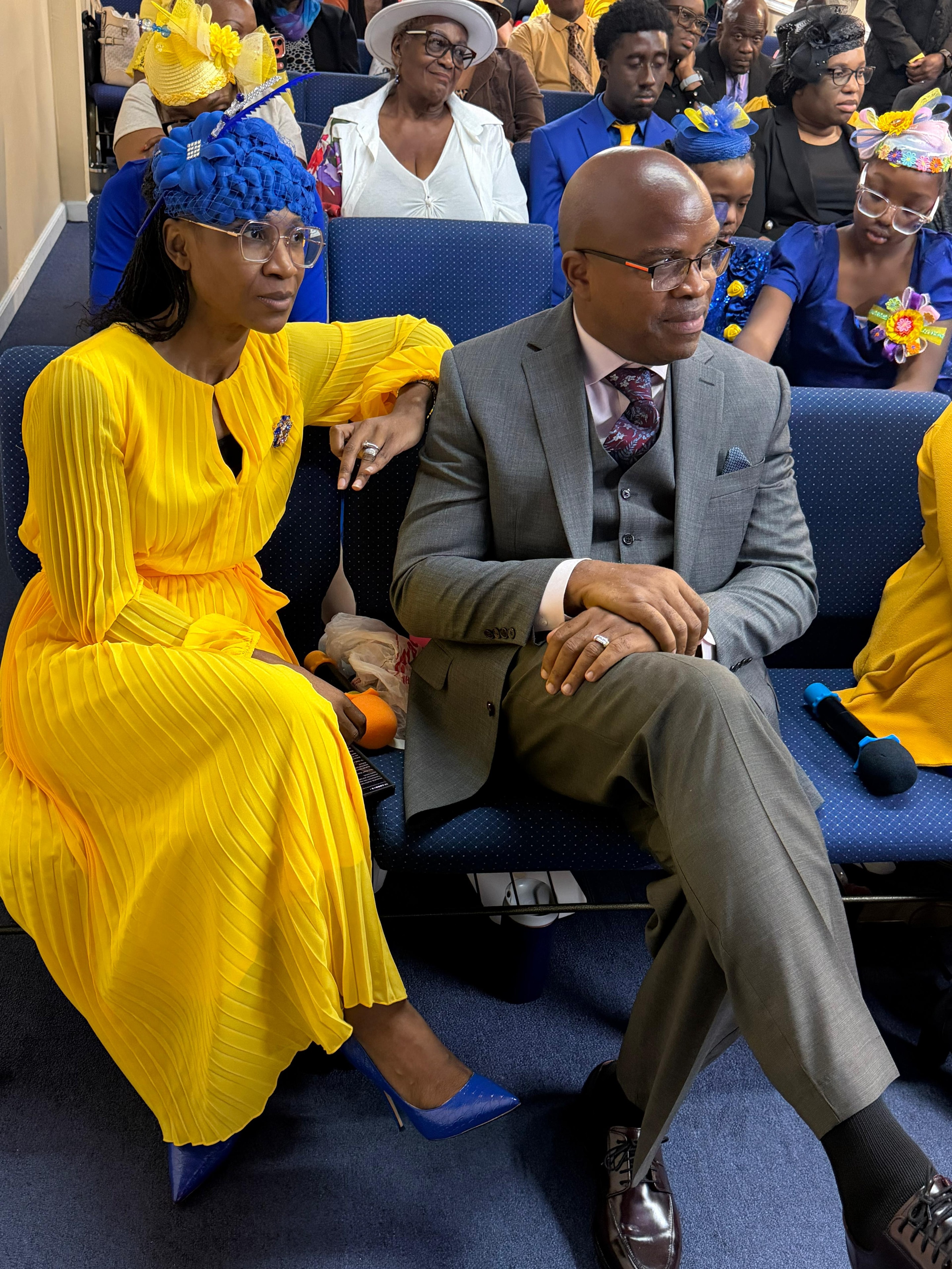 Church members in blue and yellow attire at a service