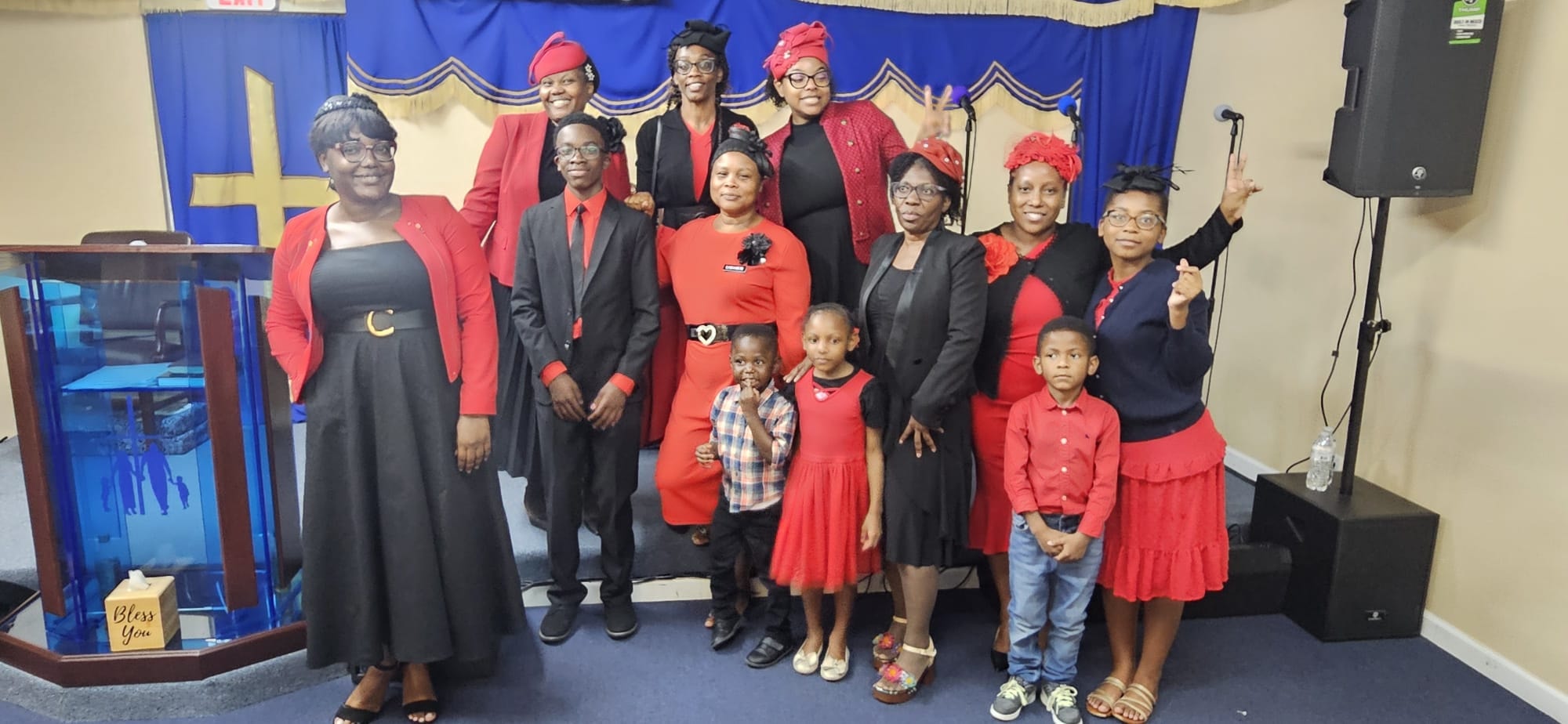 Church family in red and black attire at a service